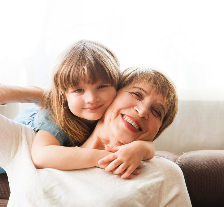 Mother and child smiling together representing dental crowns in Spokane, WA