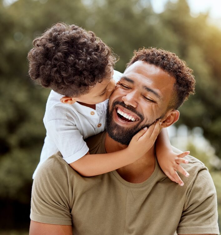 Father and child smiling together showing family dentistry in Spokane, WA