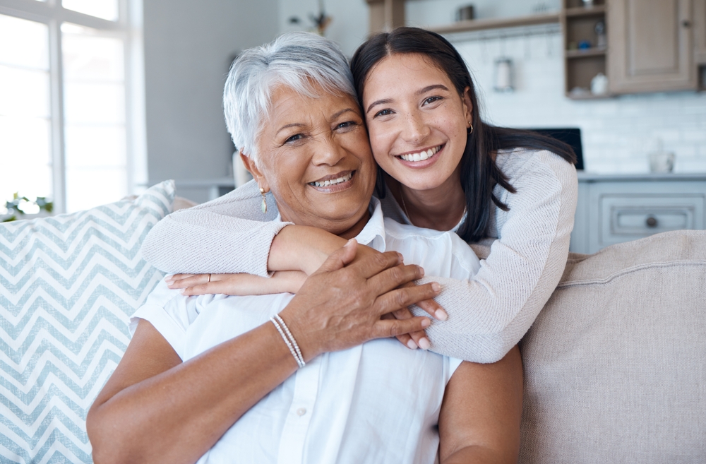 Grandmother and granddaughter hugging with healthy smiles in Spokane, WA dental extractions
