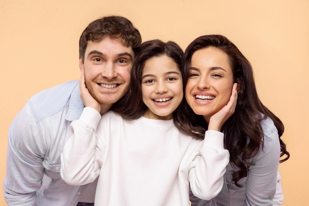 Happy family smiling with healthy teeth showing comprehensive dental cleanings and exams in Spokane, WA