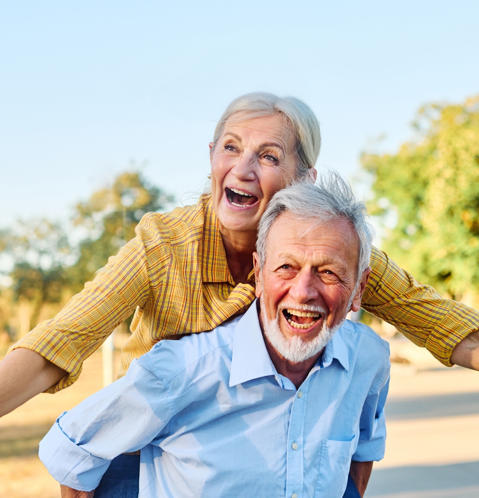 Happy senior couple with bright smiles representing senior dental care in Spokane, WA