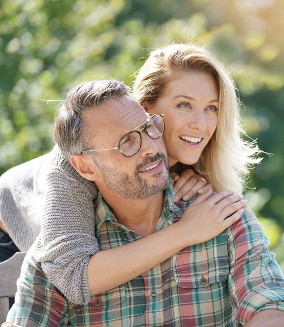 Smiling couple with healthy teeth representing cosmetic and Dental Implant Restorations in Spokane, WA